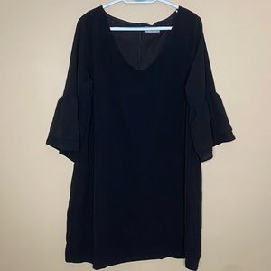 Black tunic dress with ruffled sleeves.